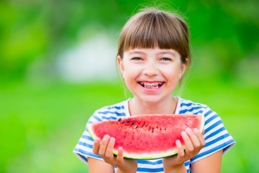 Child eating watermelon.