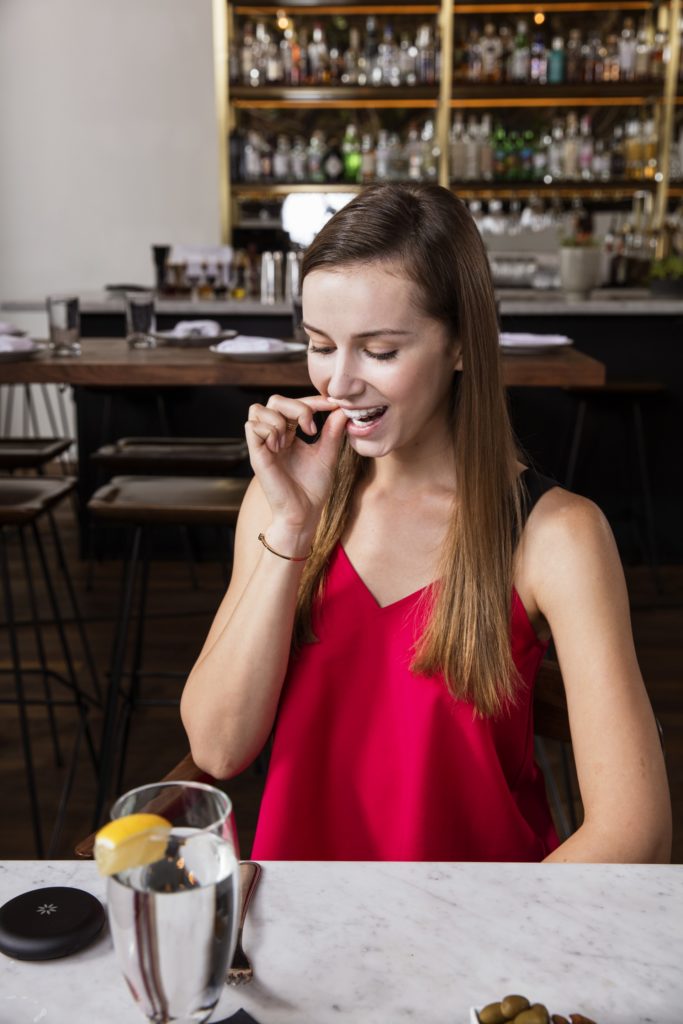 girl using Invisalign retainer