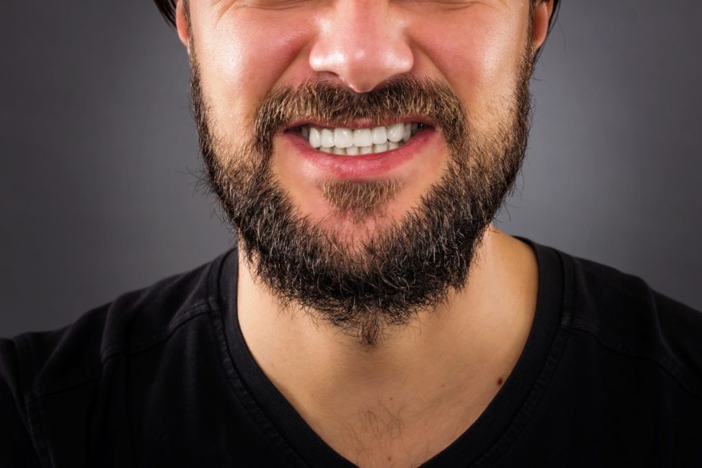 man who is grinding his teeth